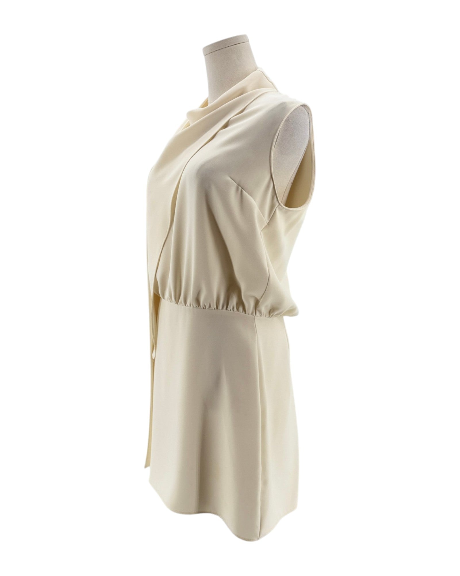 Beige sleeveless dress on a mannequin against a white background