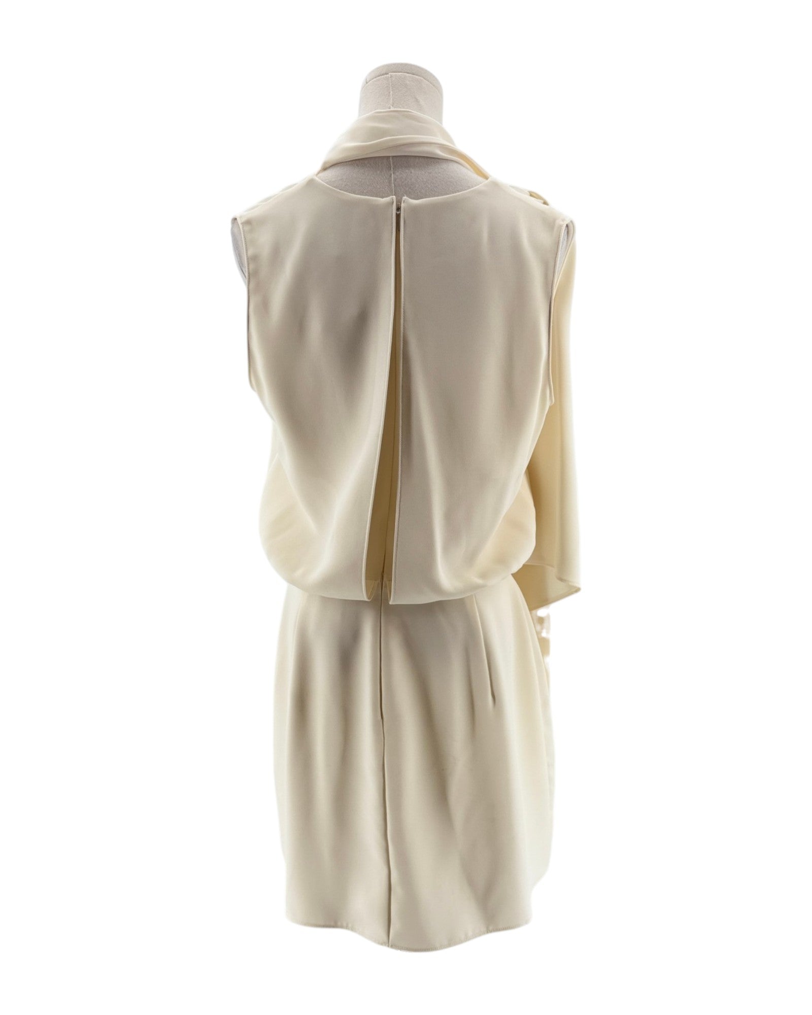 Mannequin wearing a cream-colored outfit with a vest and skirt on a white background