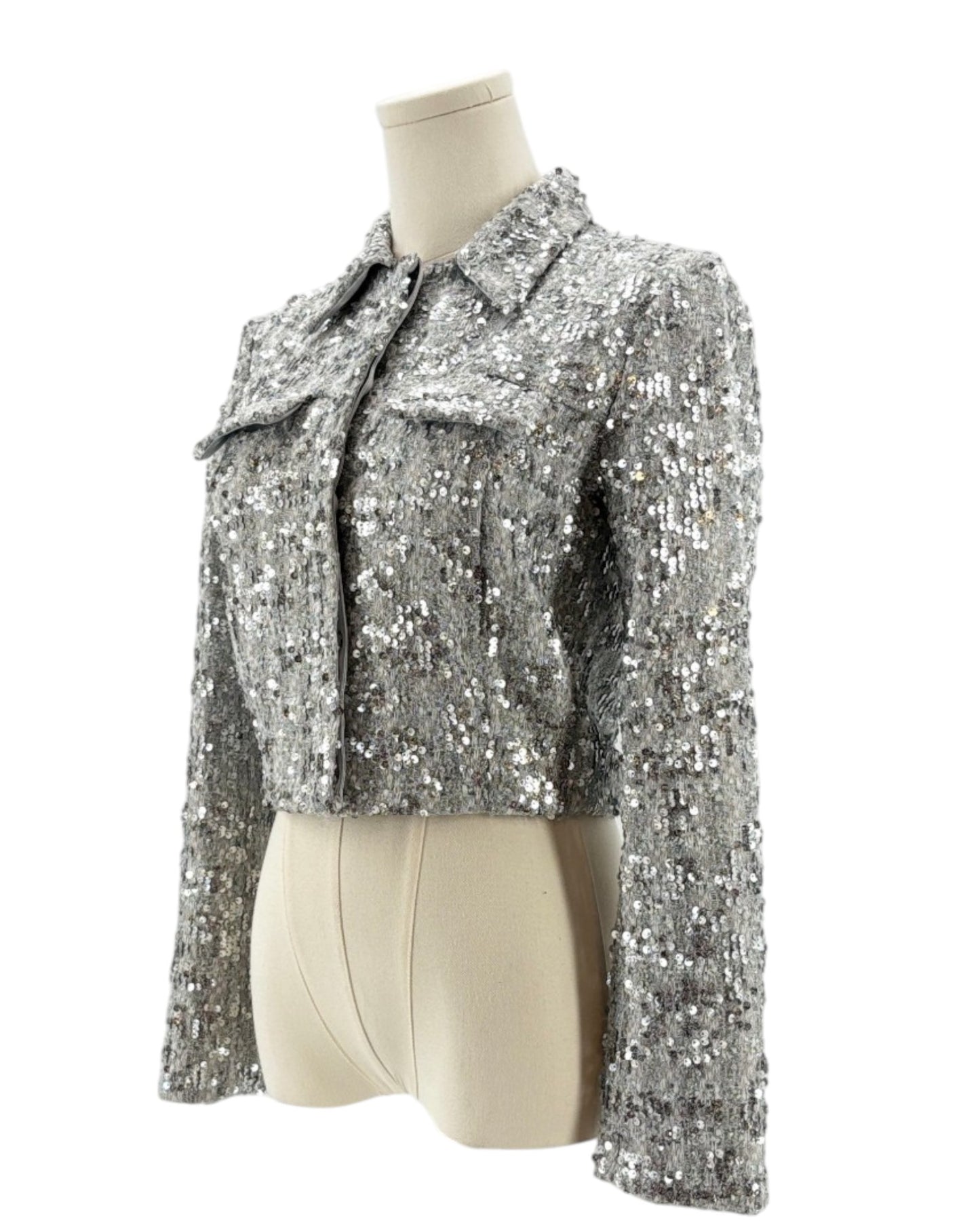 Amanda Uprichard silver sequin jacket on a mannequin against a white background