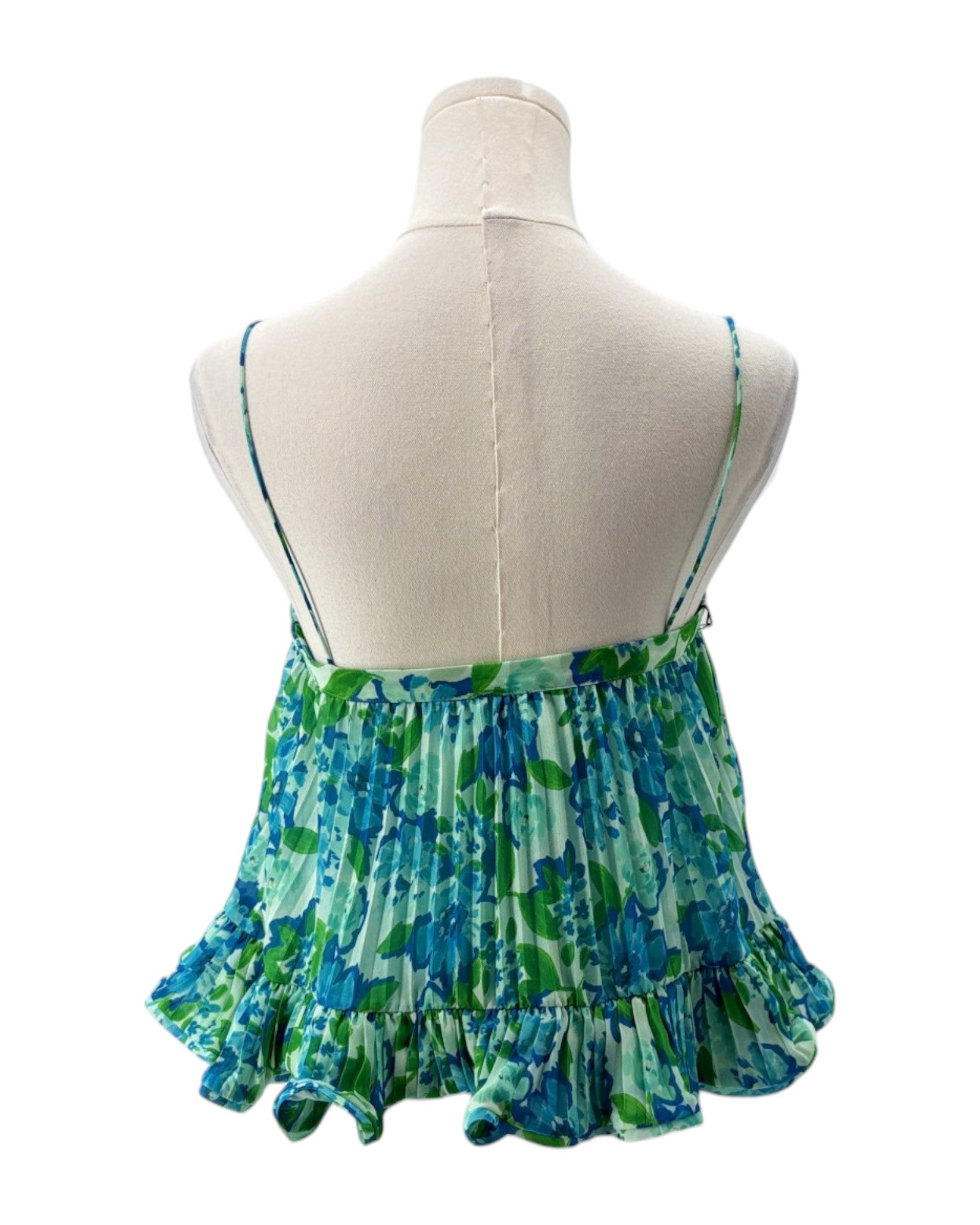 Green and blue patterned top on a mannequin with a white background