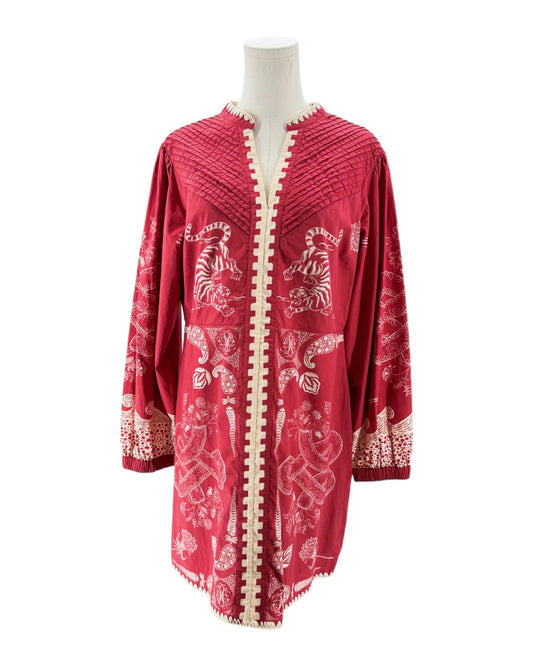 Red dress with white patterns on a mannequin against a white backgroun