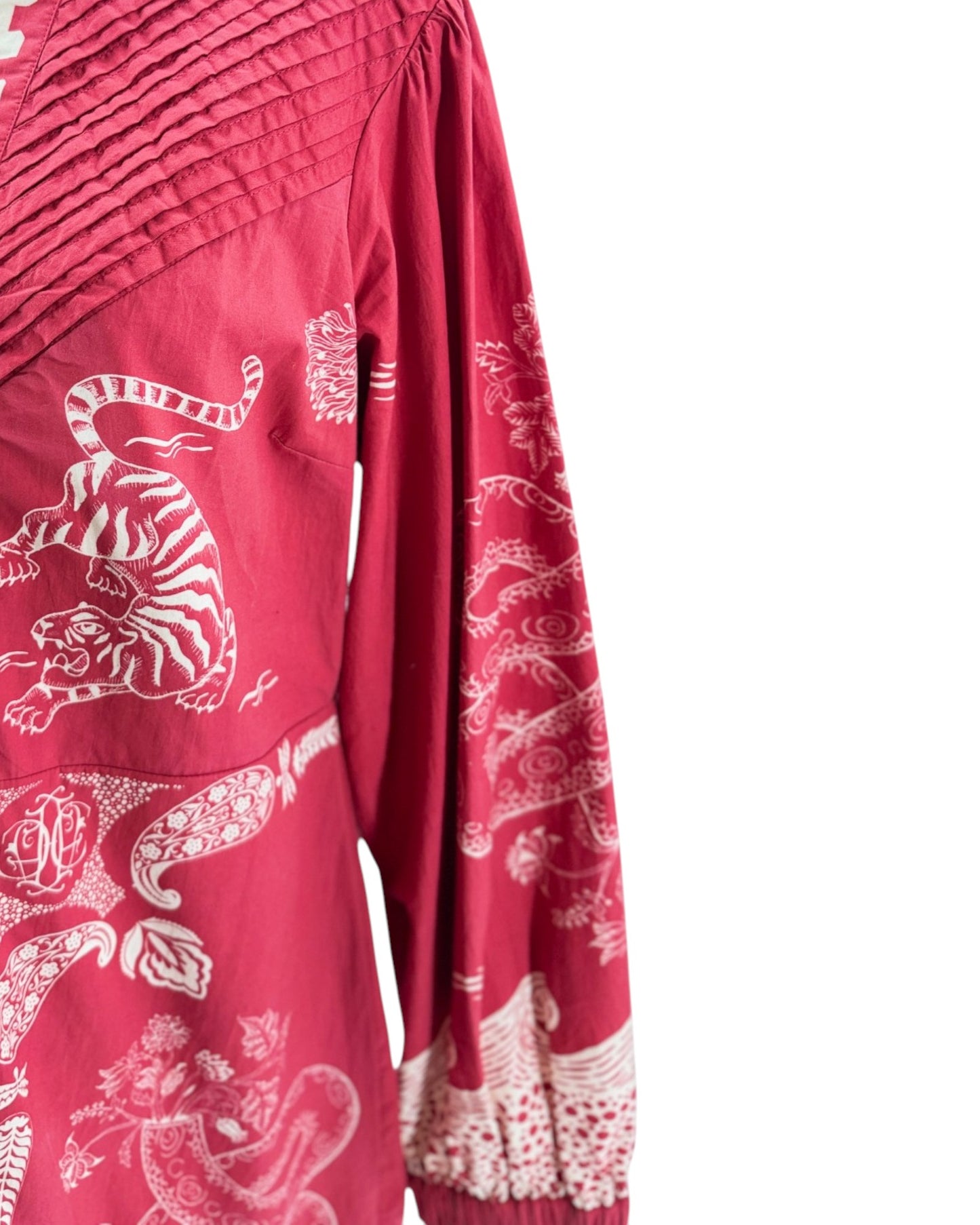 Red garment with white tiger and floral patterns on a white background