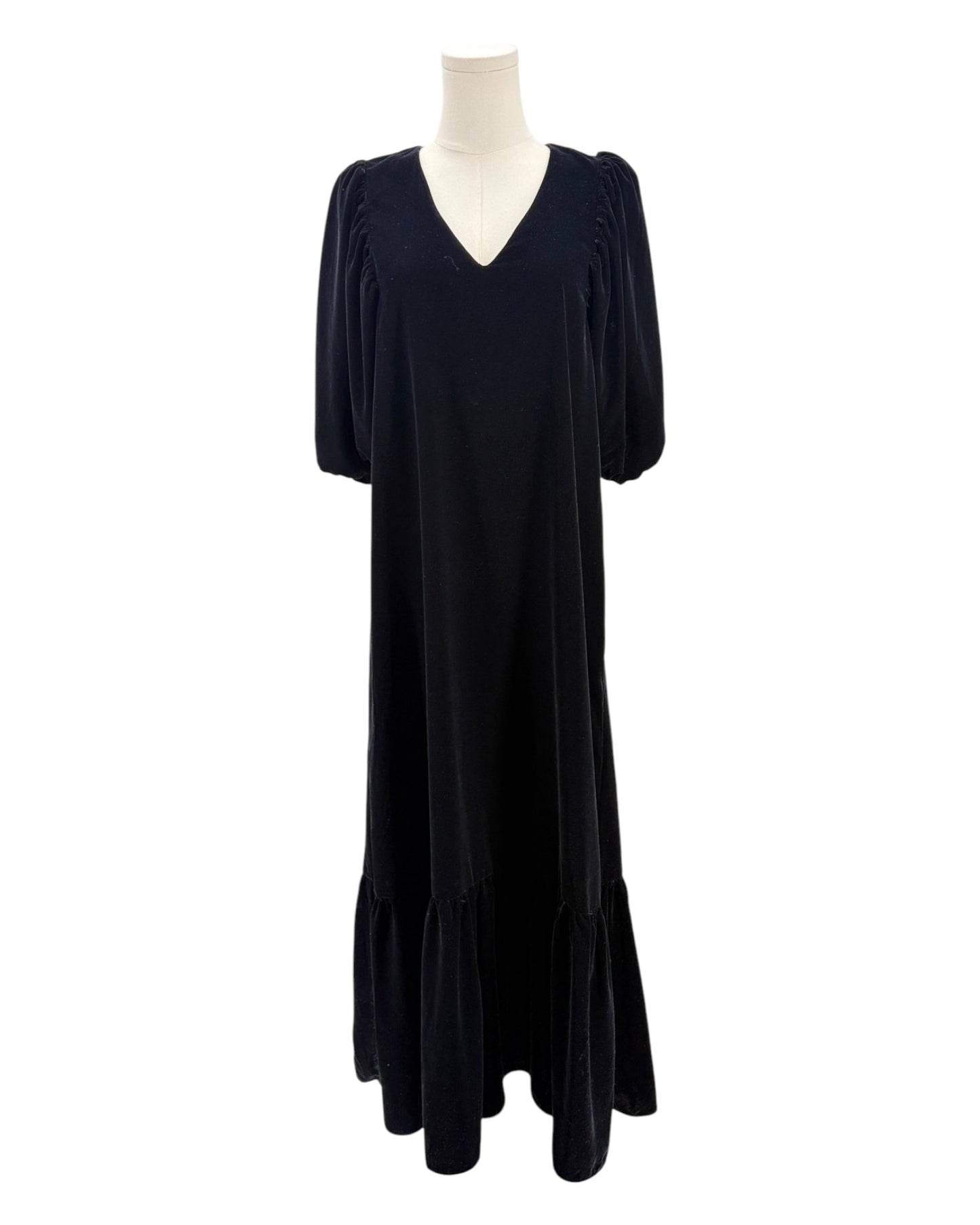 Black dress on a mannequin against a white background