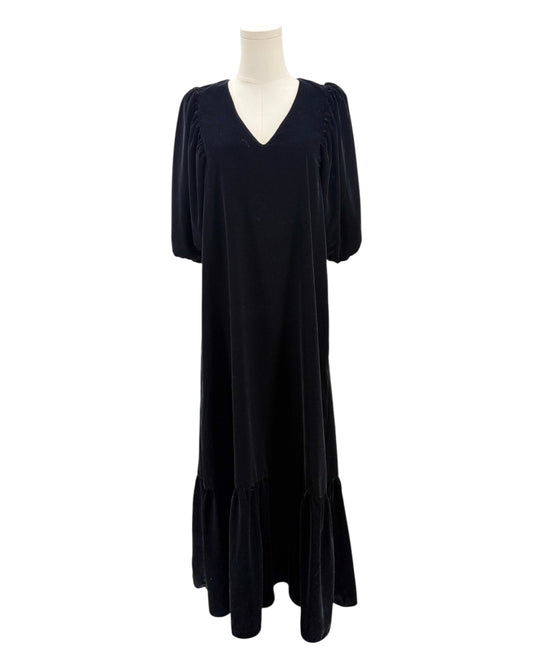 Black dress on a mannequin against a white background