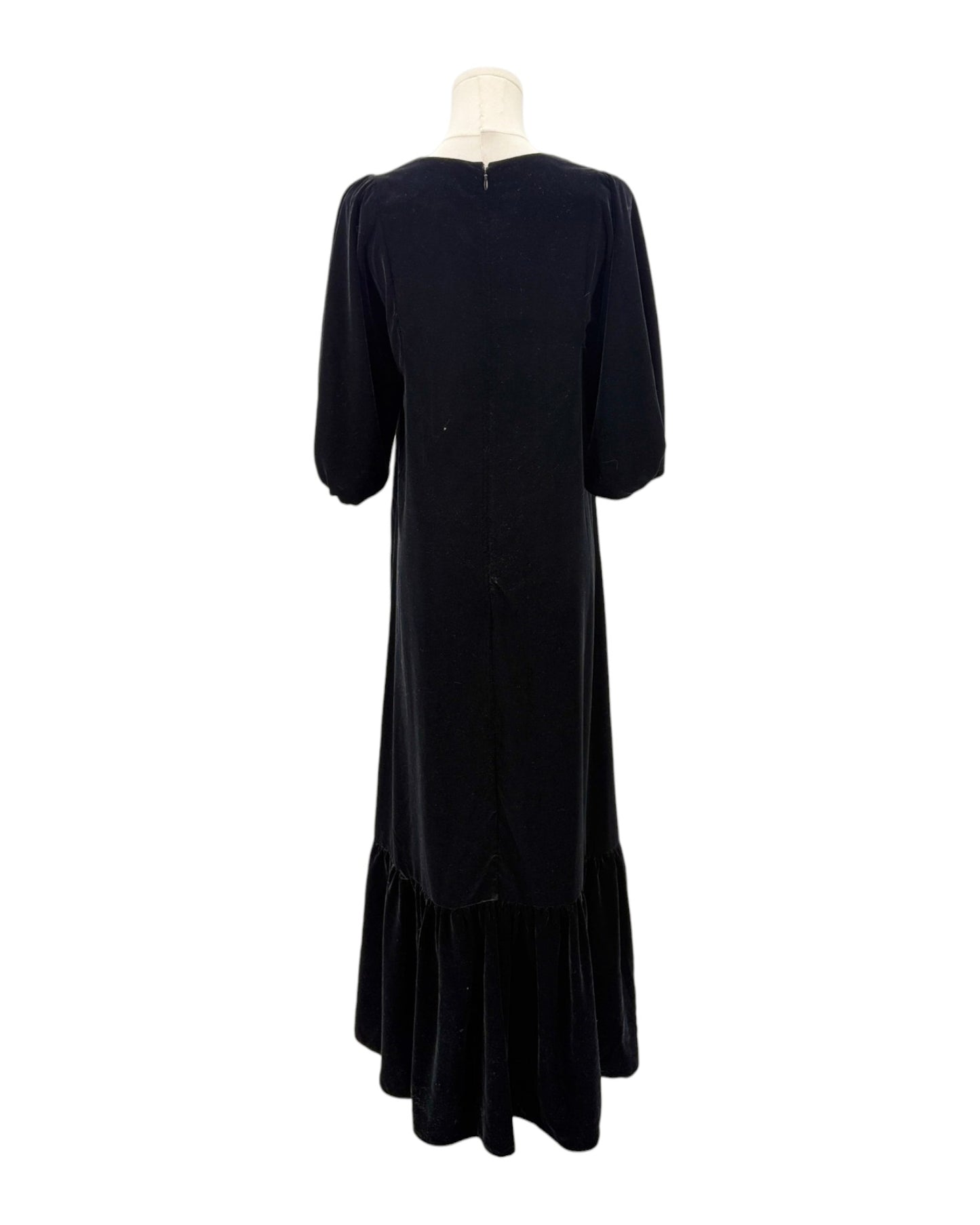 Black dress on a mannequin against a white background