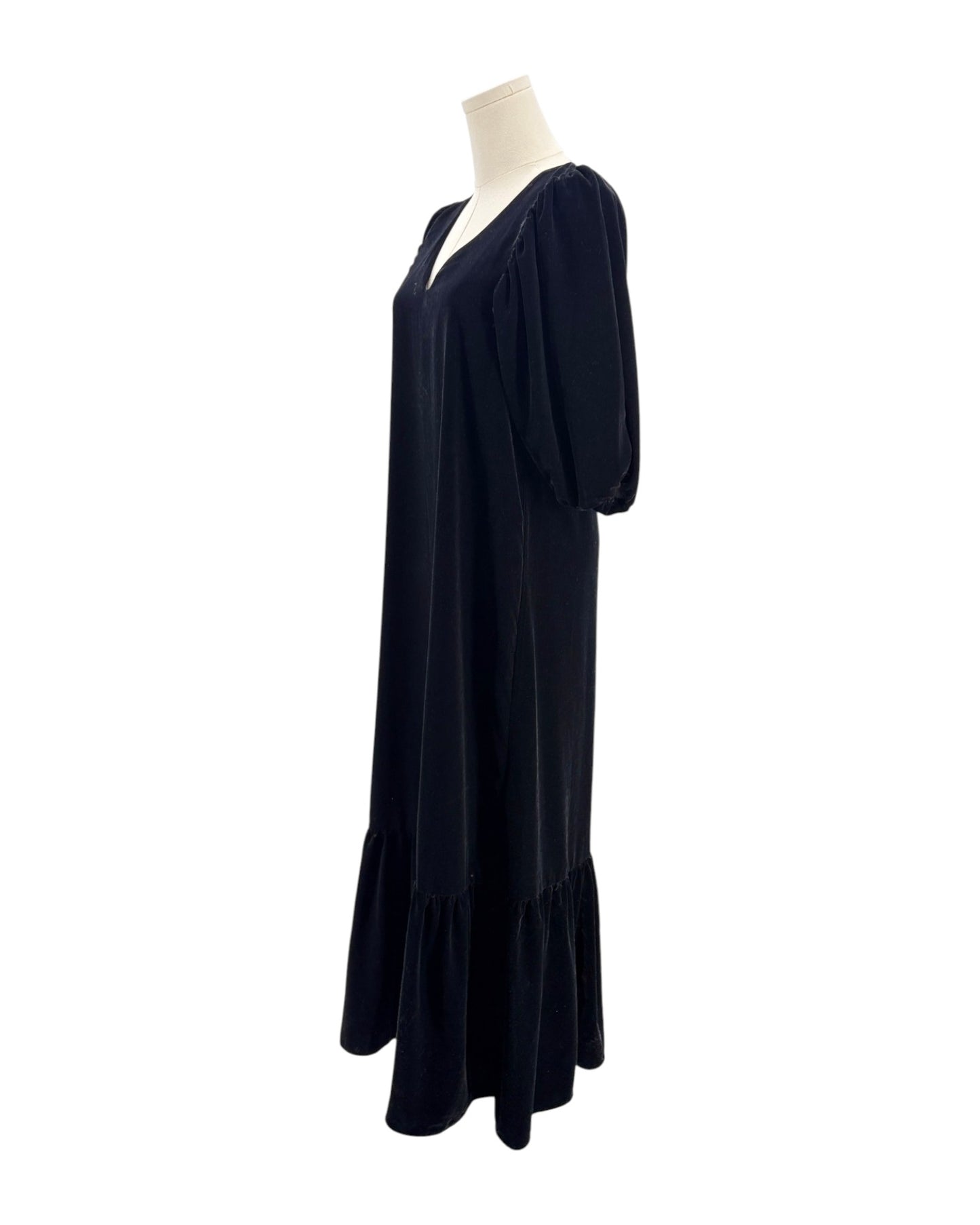 Black dress on a mannequin against a white background
