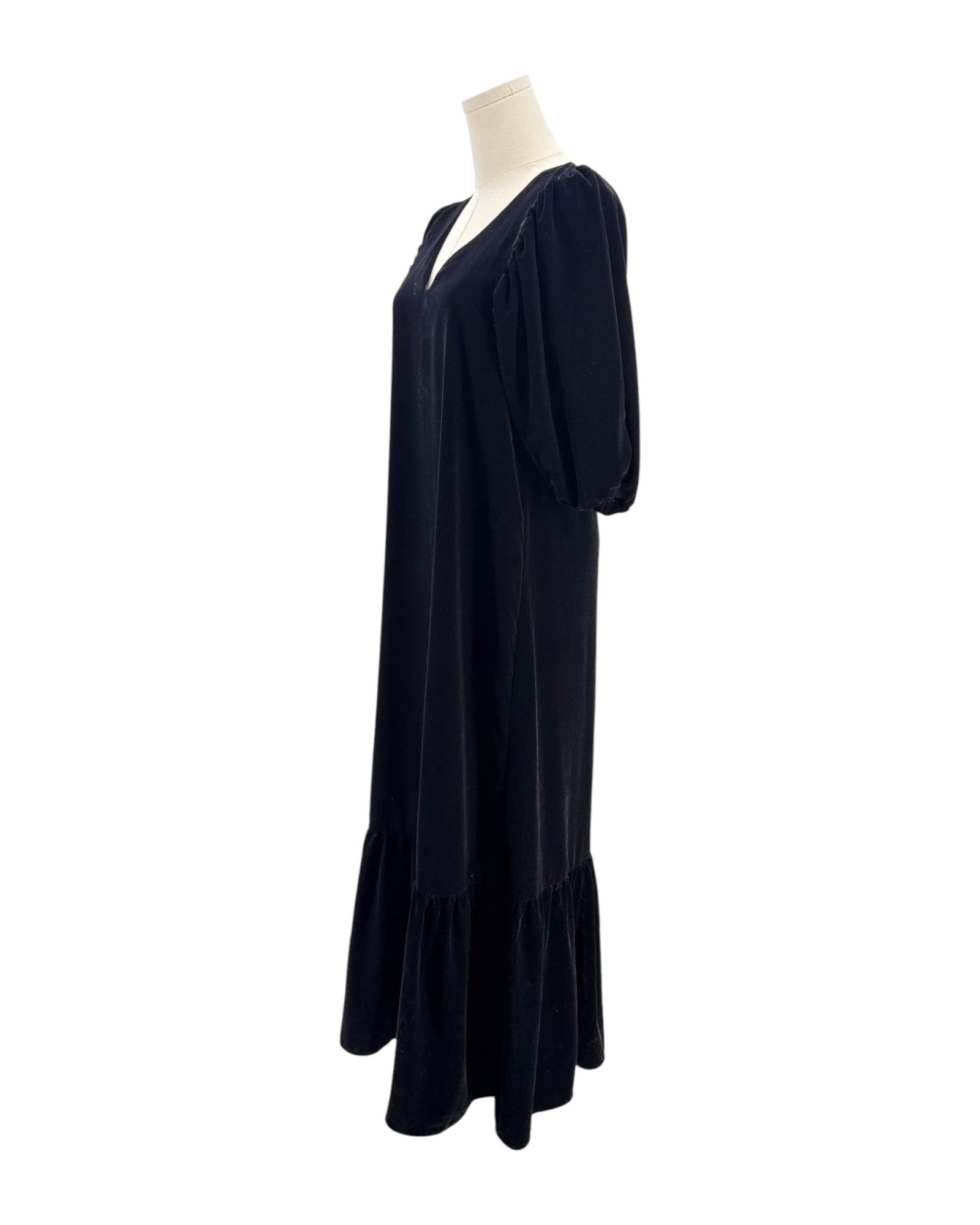 Black dress on a mannequin against a white background