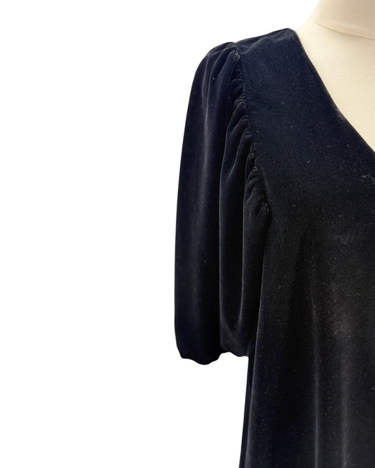 Black dress on a mannequin with a white background