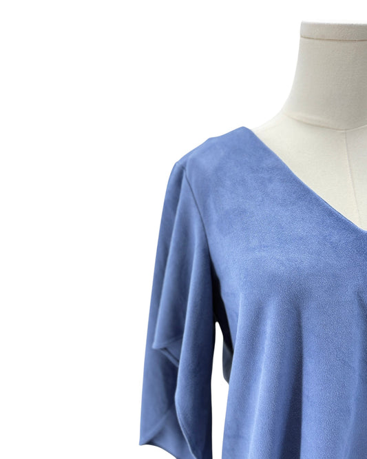 Blue blouse on a mannequin against a white background