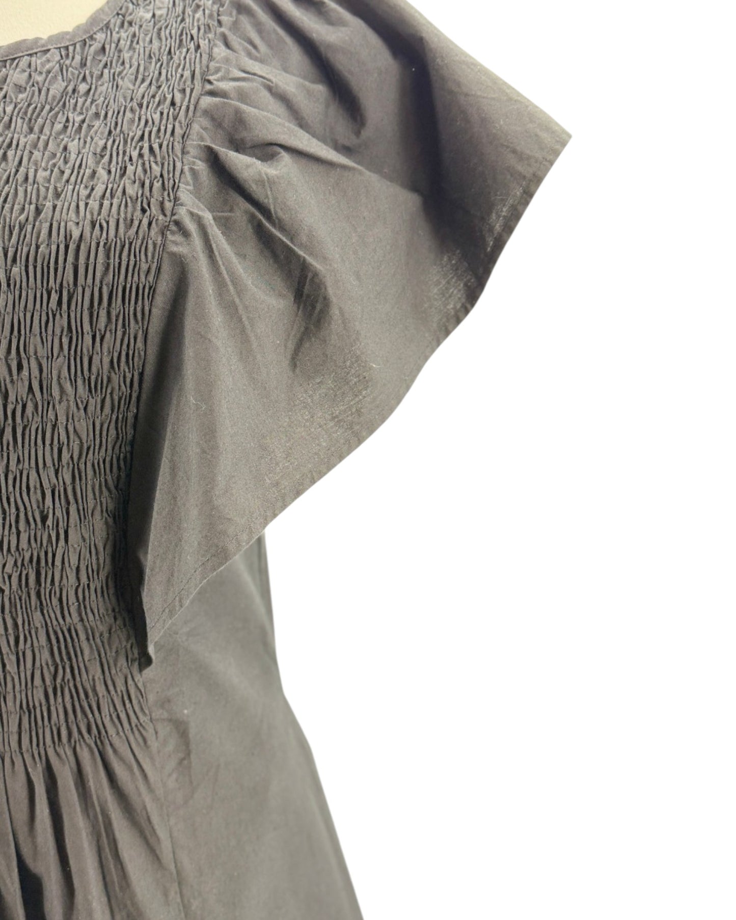 Black dress on a mannequin against a white background