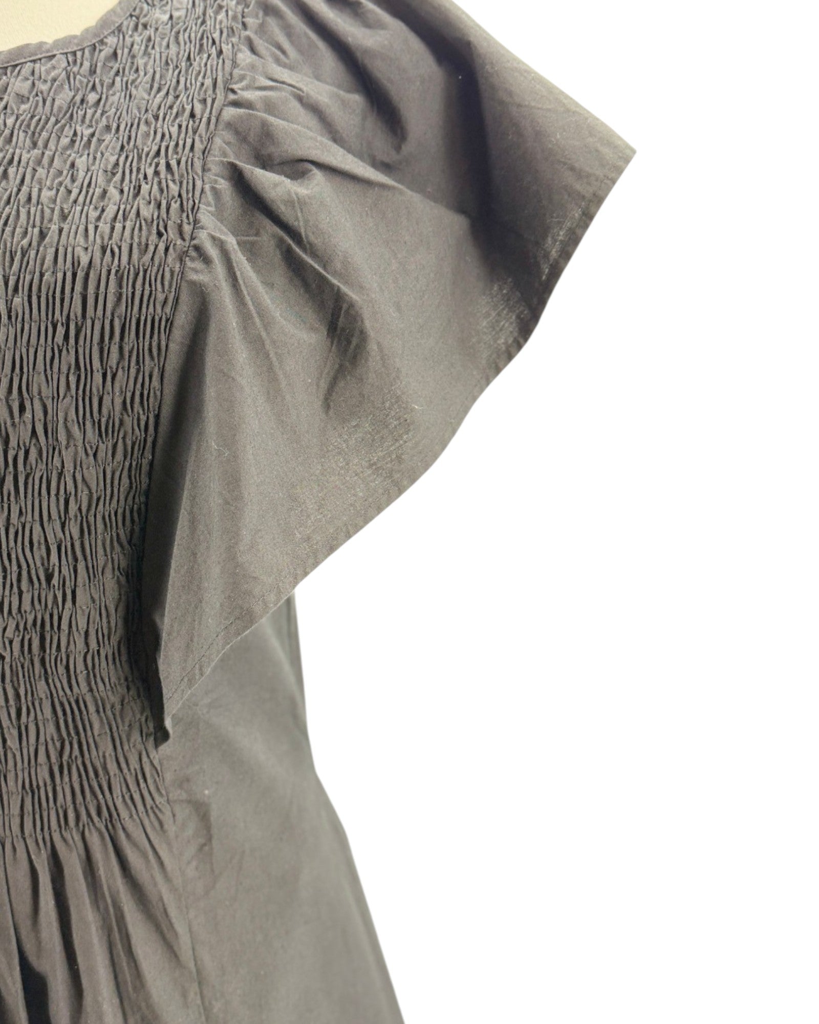 Black dress on a mannequin against a white background