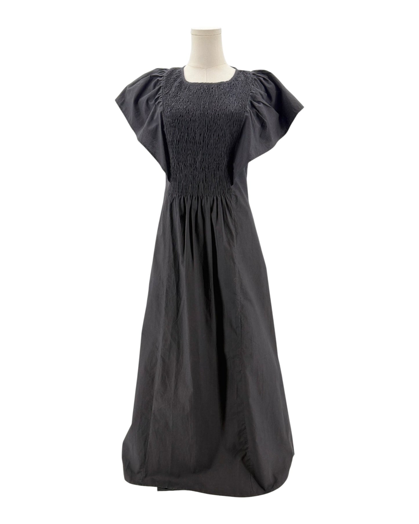 Black dress on a mannequin against a white background