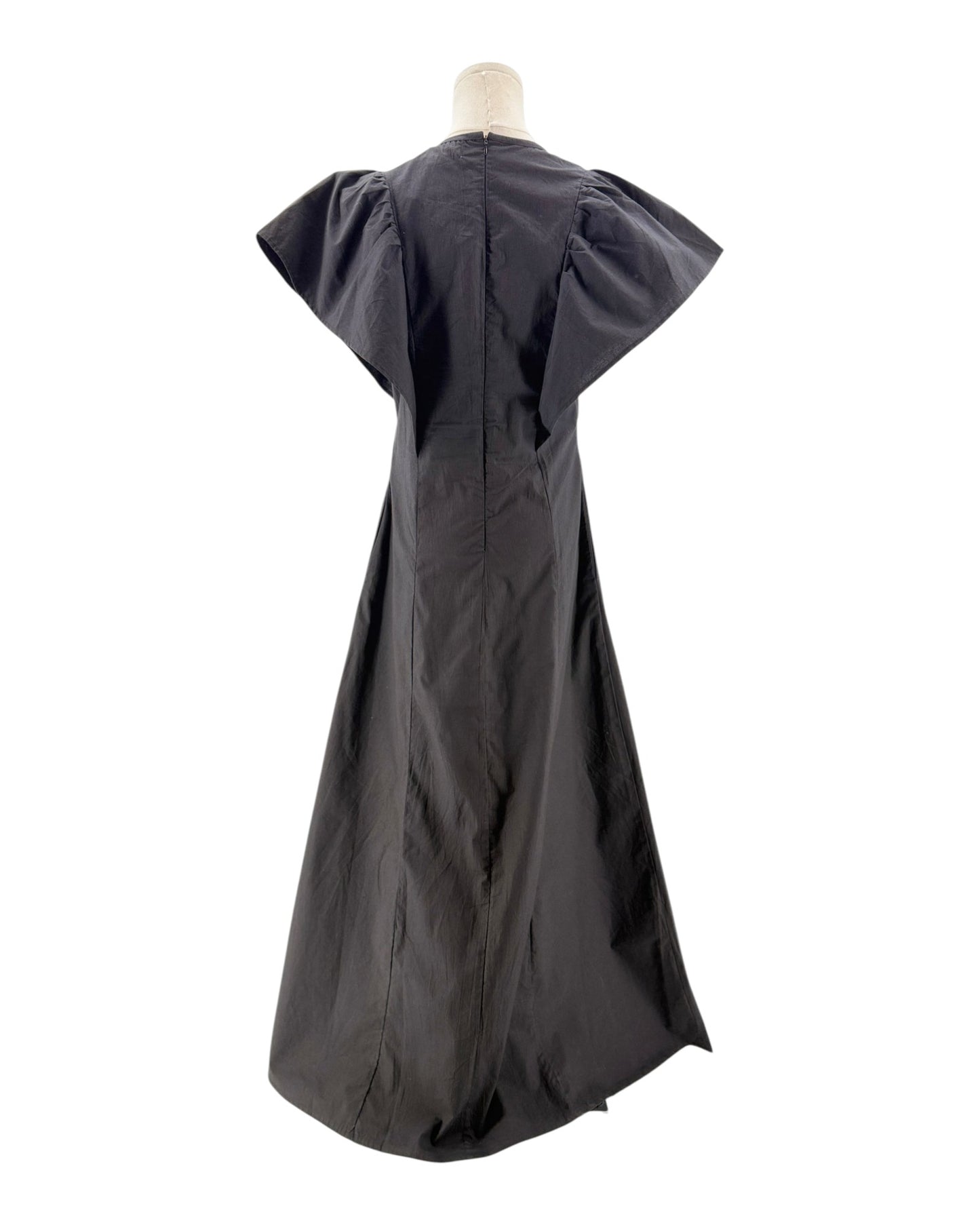 Black dress on a mannequin against a white background