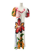 Mannequin wearing a colorful floral dress on a white background