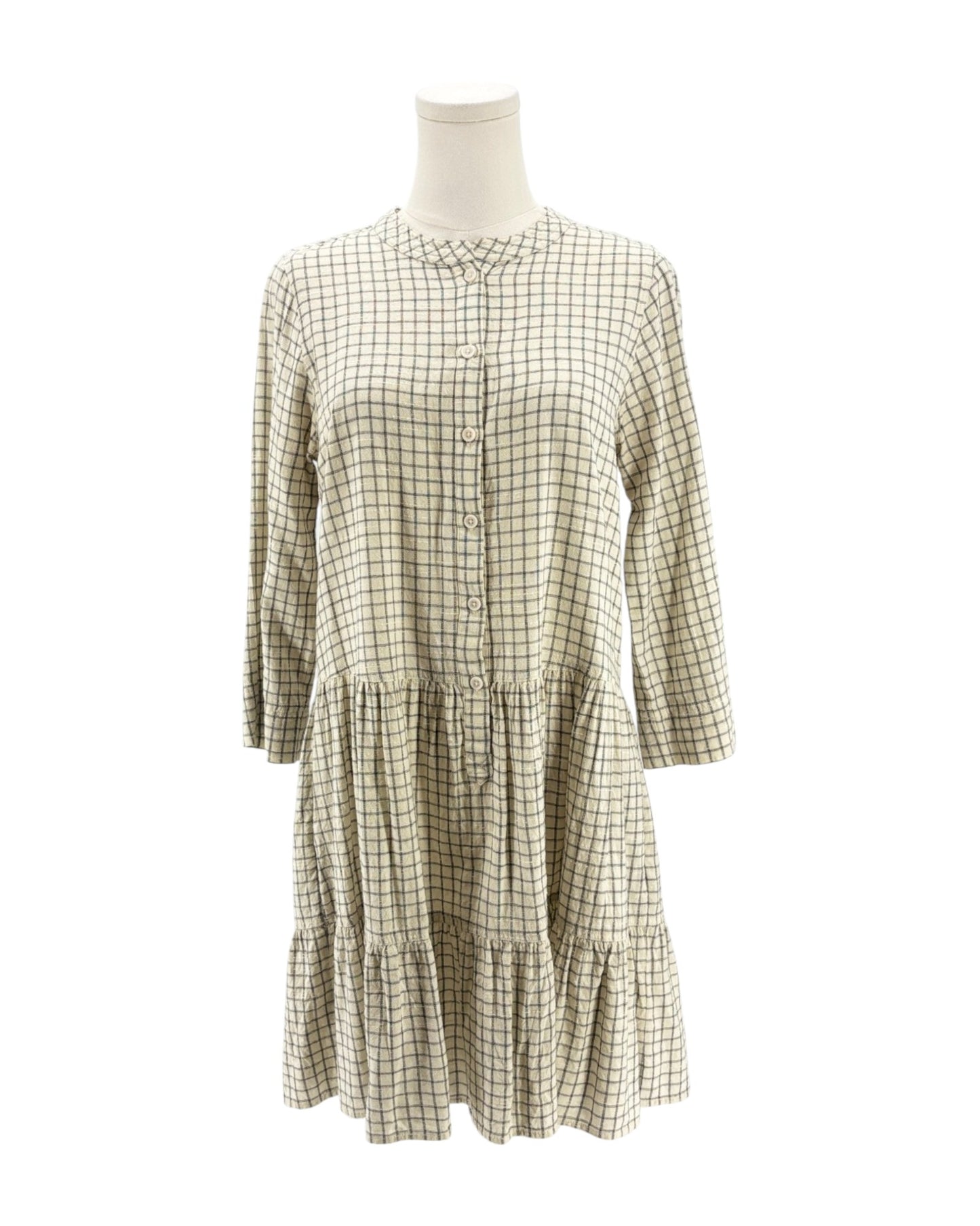 Checkered dress on a mannequin against a white background