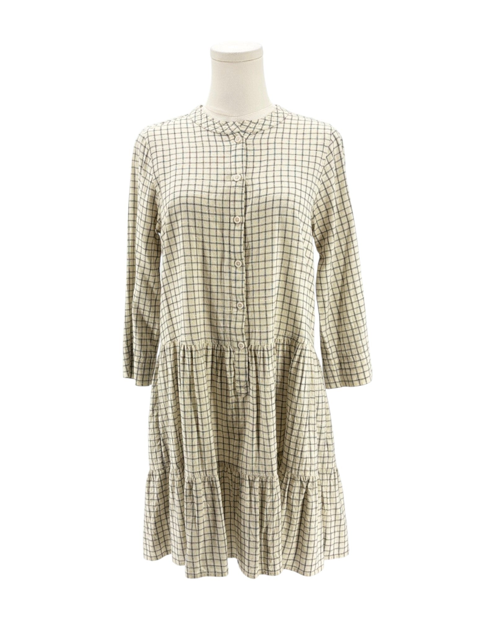 Checkered dress on a mannequin against a white background
