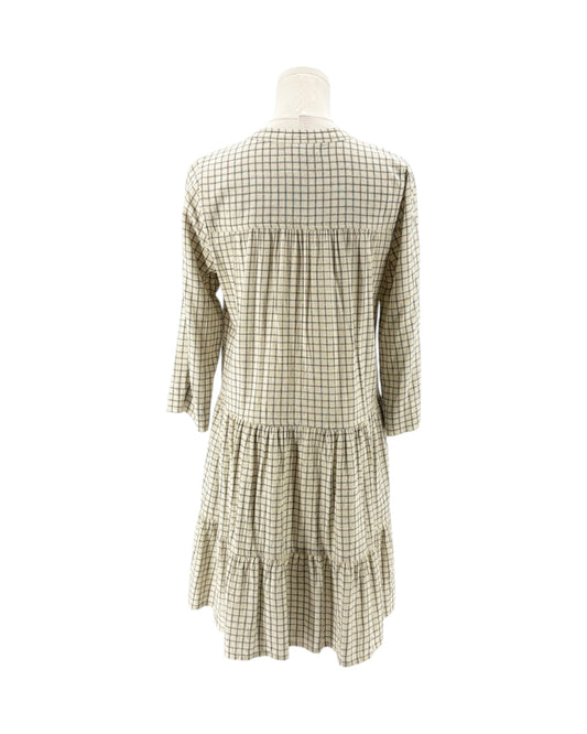Green and white checkered dress on a mannequin against a white background