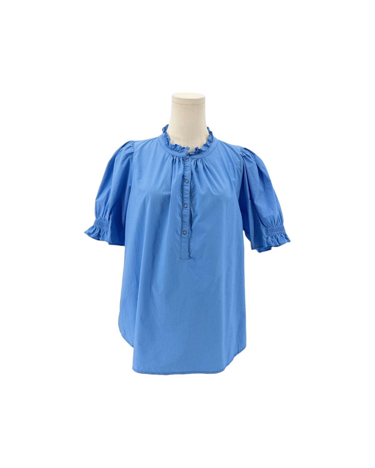 A light blue short-sleeve blouse with ruffled trim at the collar and cuffs, displayed on a cream mannequin torso against a plain white background.