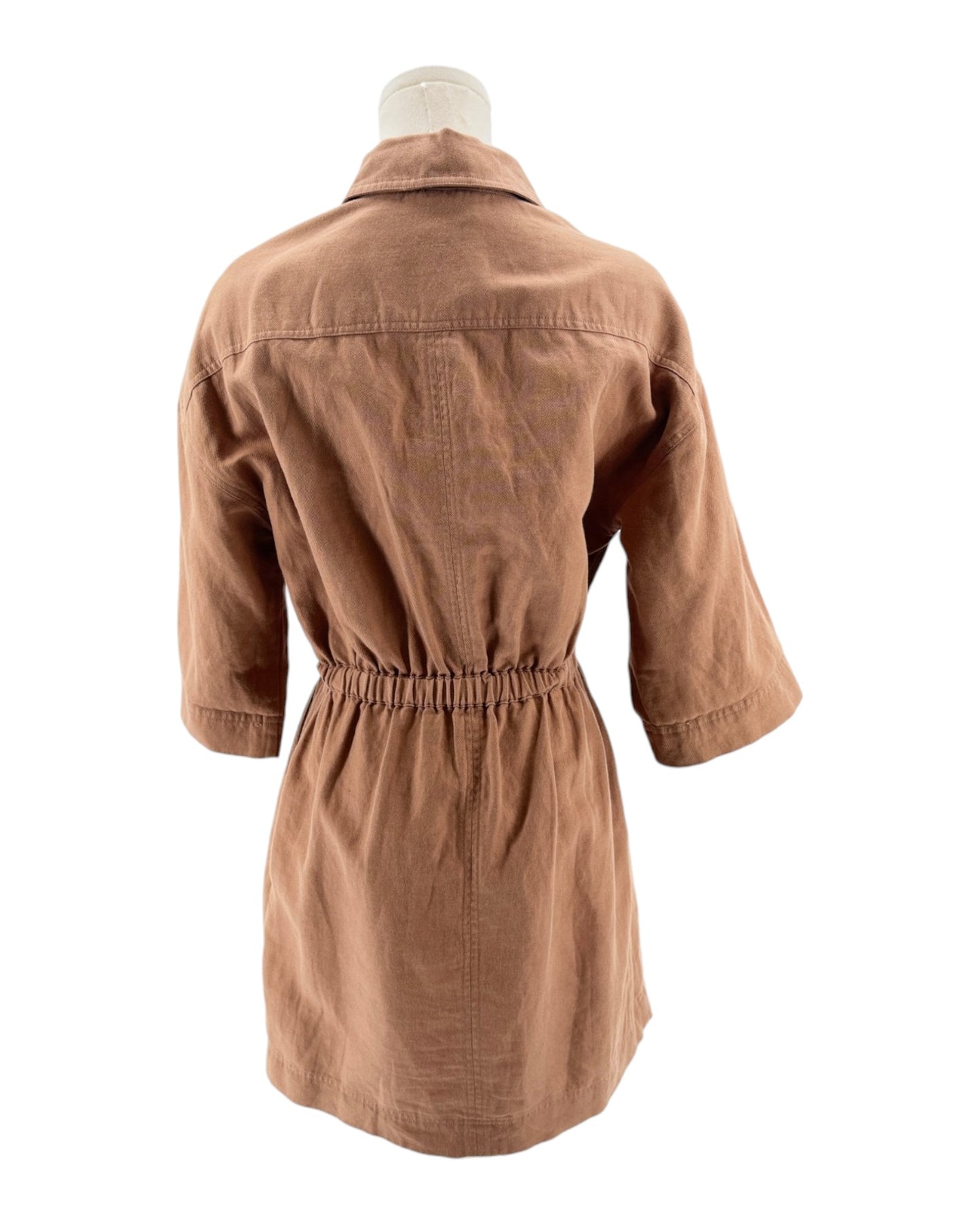 Brown dress on a mannequin against a white background