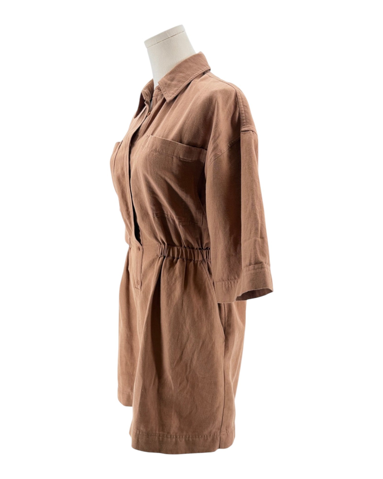 Brown dress on a mannequin against a white background
