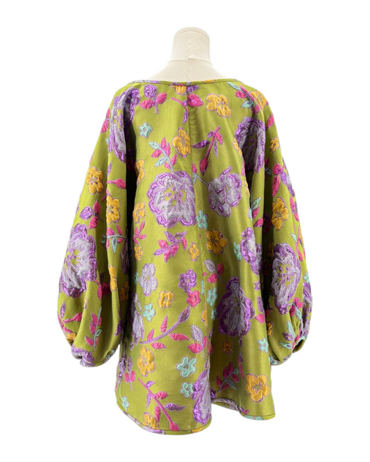 Mannequin wearing a colorful floral patterned Arianne Elmy tunic dress on a white background