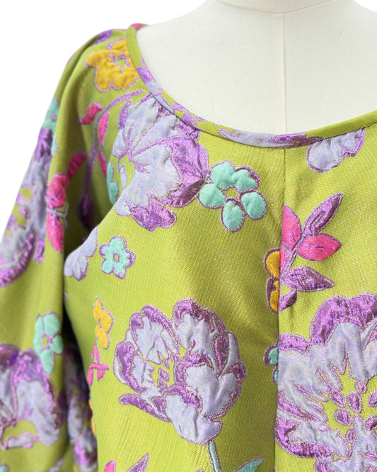 Mannequin wearing a colorful floral patterned Arianne Elmy tunic dress on a white background