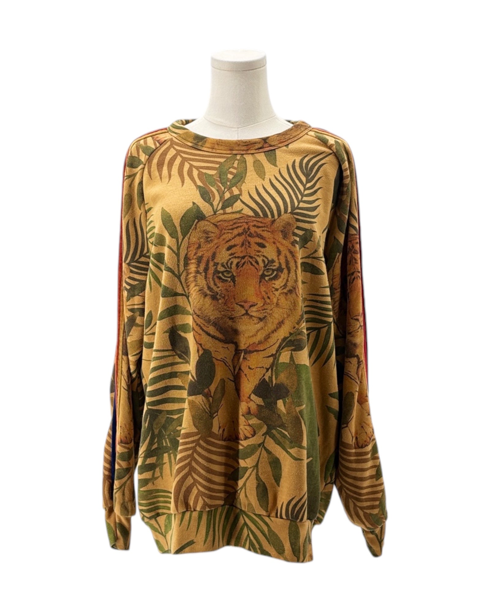 Sweatshirt with tiger and leaf pattern on a mannequin against a white background