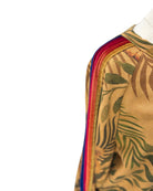 Close-up of a garment with a colorful sleeve and leaf pattern on a white background