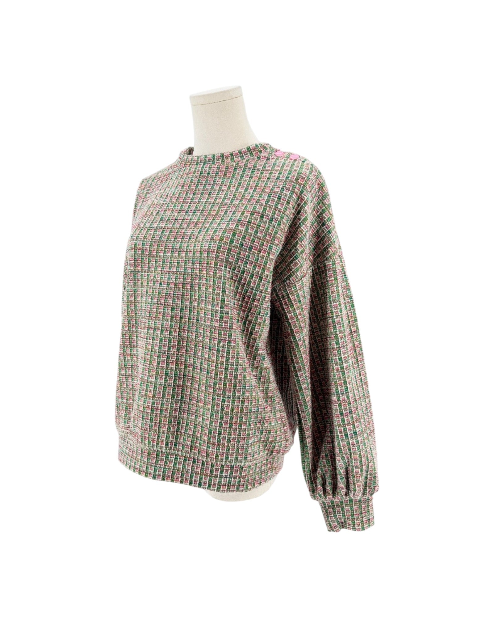 A textured knit sweater with a multicolor plaid pattern of green, pink, and beige, displayed on a mannequin torso against a white background.