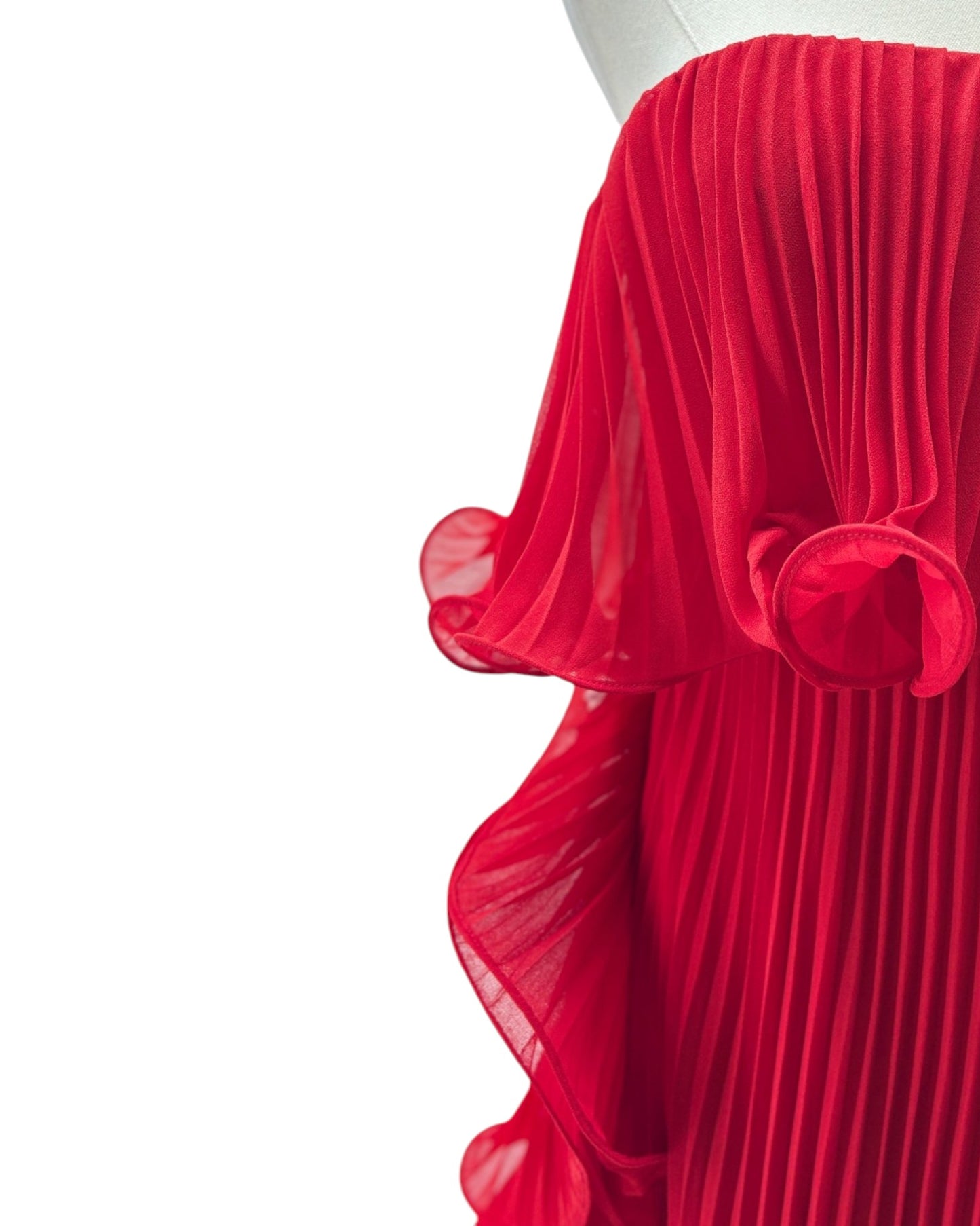 Red pleated skirt on a mannequin against a white background
