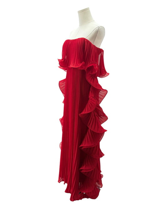 Red ruffled dress on a mannequin against a white background