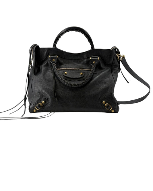 Black handbag with gold hardware on a white background