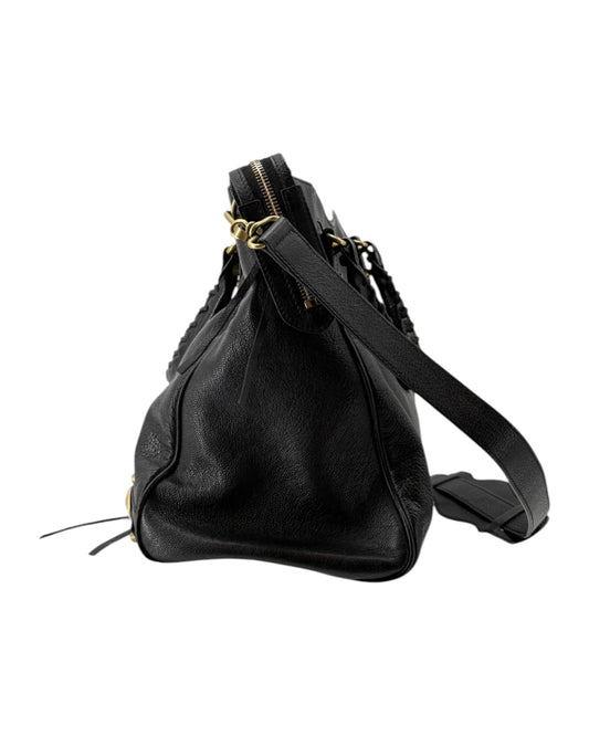 Black leather handbag with gold zipper on a white background