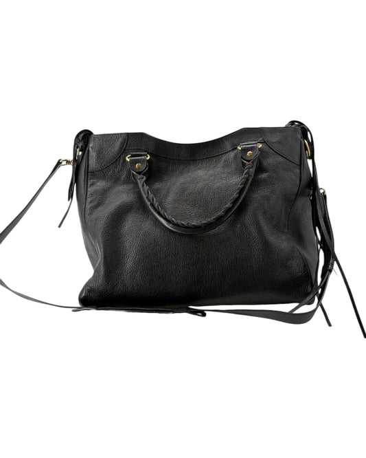 Black leather handbag with a shoulder strap on a white background