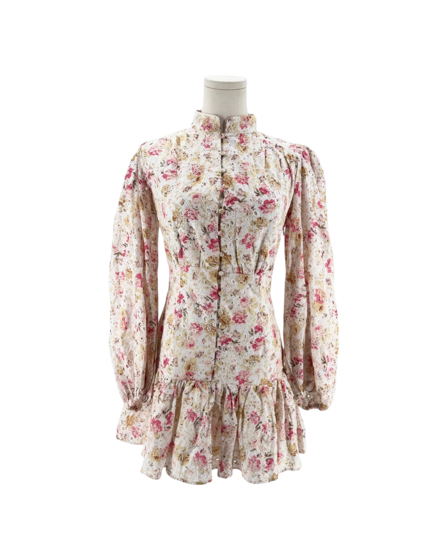 A vintage-style floral dress displayed on a mannequin torso against a plain white background. The long-sleeve dress features a high ruffled collar, button-front closure, and a ruffled hem.