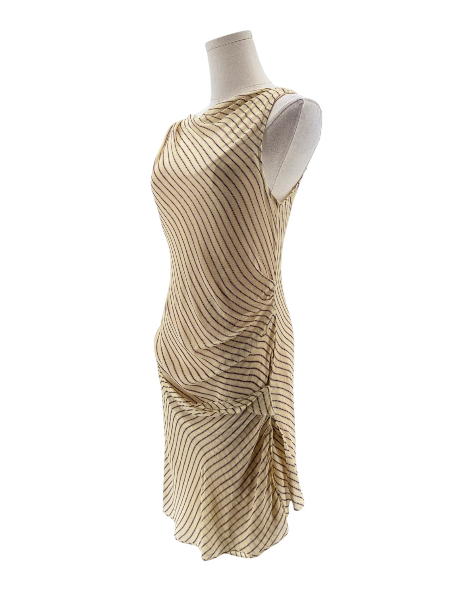 Beige and brown striped dress on a mannequin against a white background