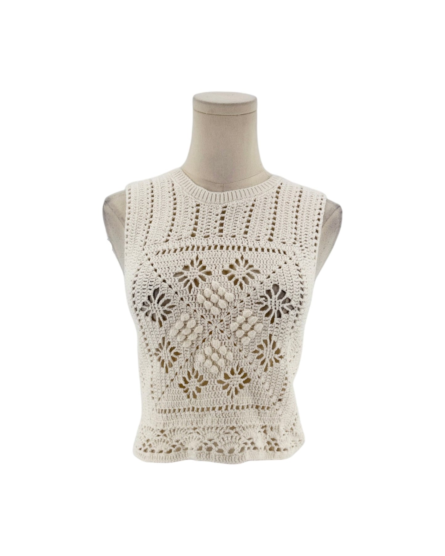 Sleeveless crochet top on a white background on a mannequin.