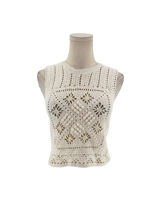 Sleeveless crochet top on a white background on a mannequin.