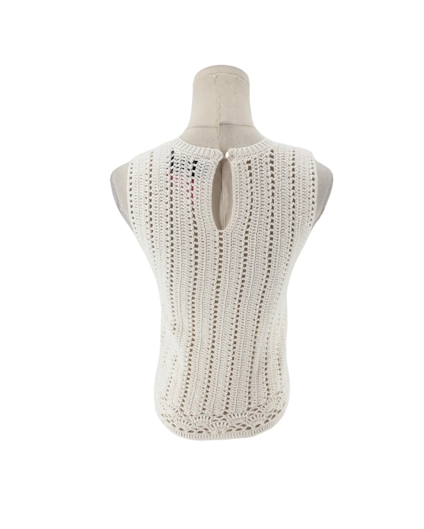 Sleeveless crochet top on a white background on a mannequin.