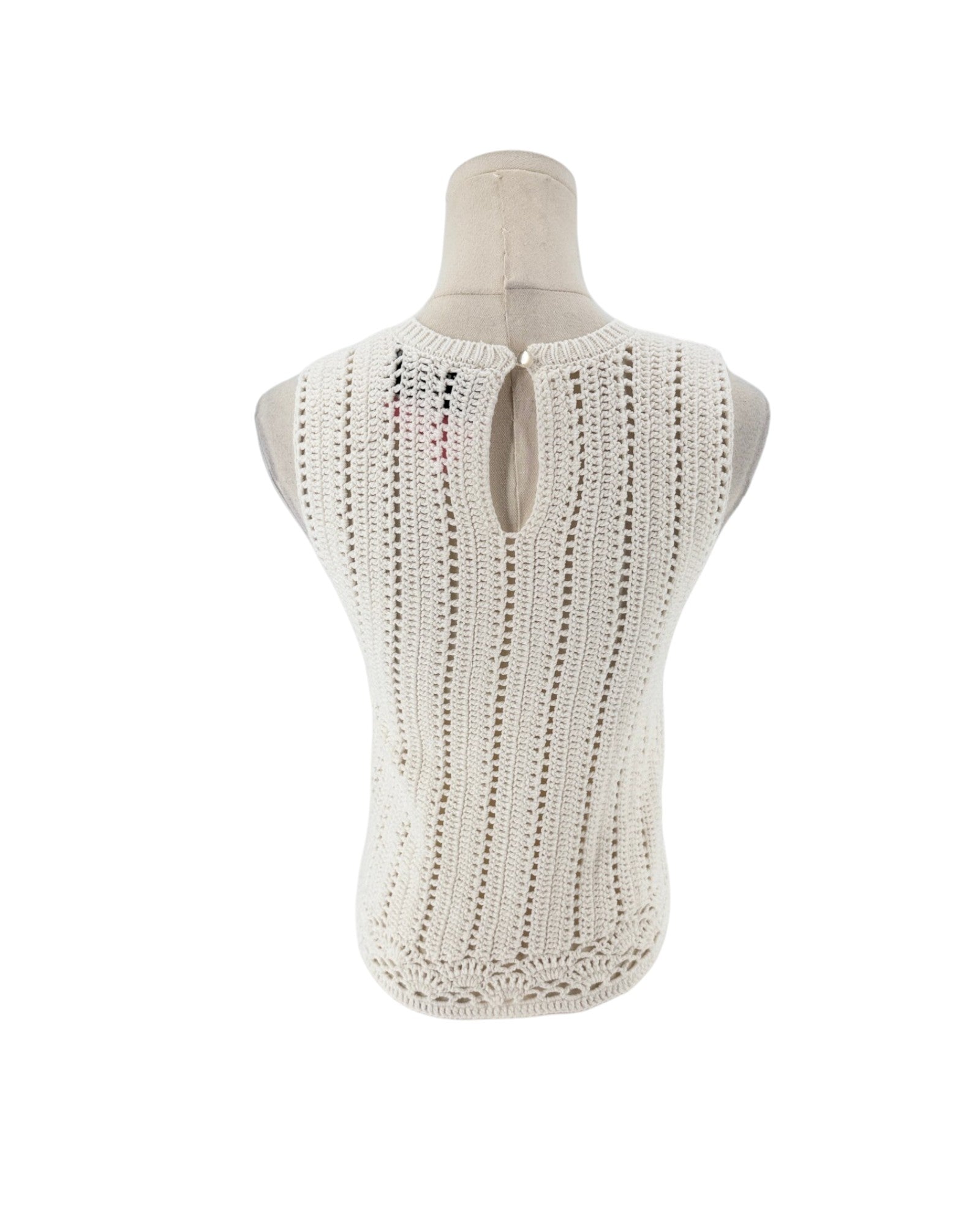 Sleeveless crochet top on a white background on a mannequin.