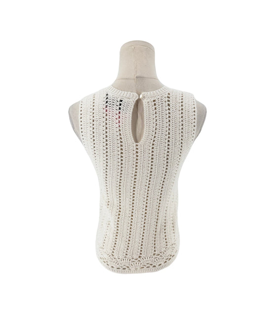 Sleeveless crochet top on a white background on a mannequin.