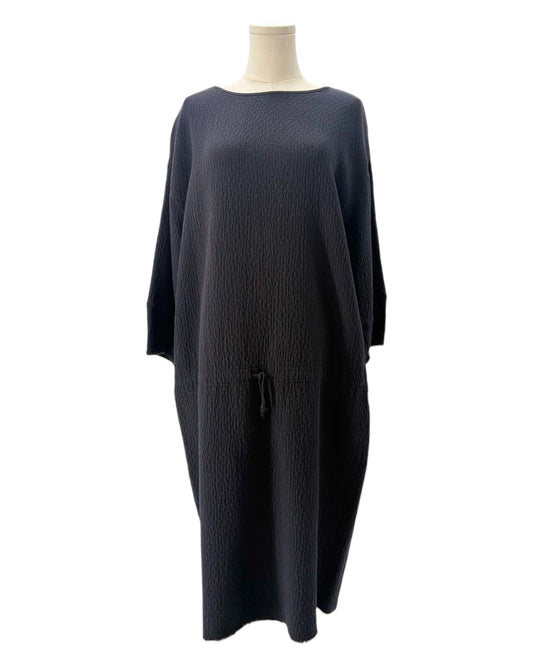 Black dress on a mannequin against a white background