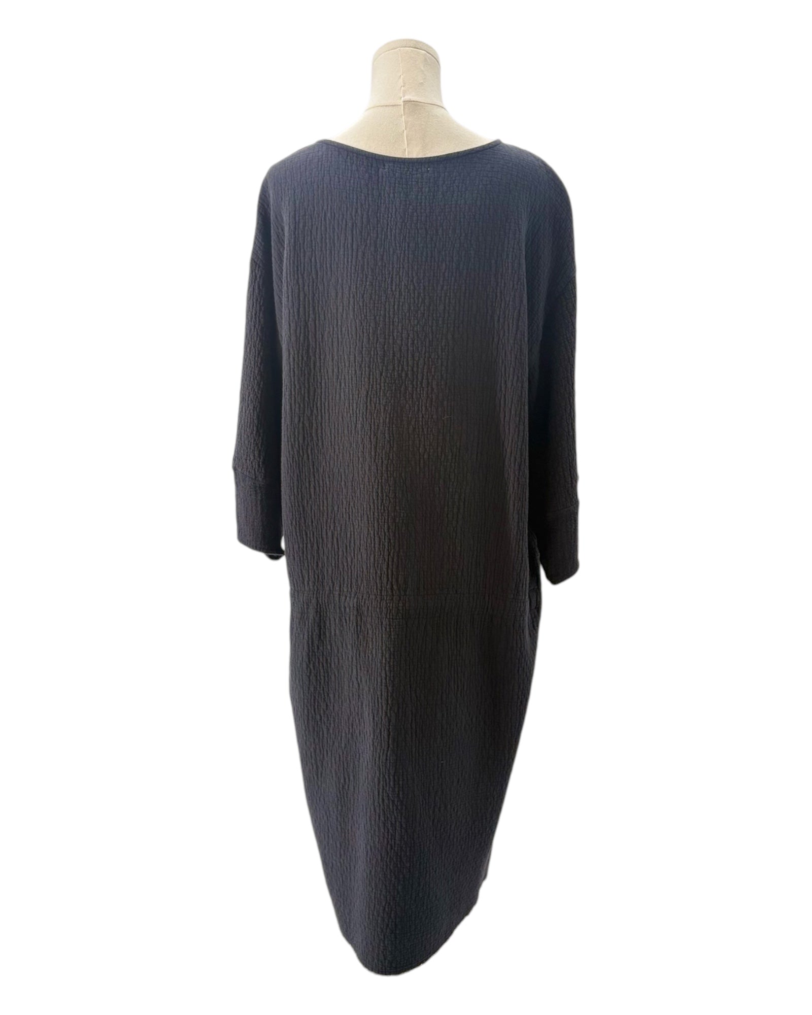Black dress on a mannequin against a white background