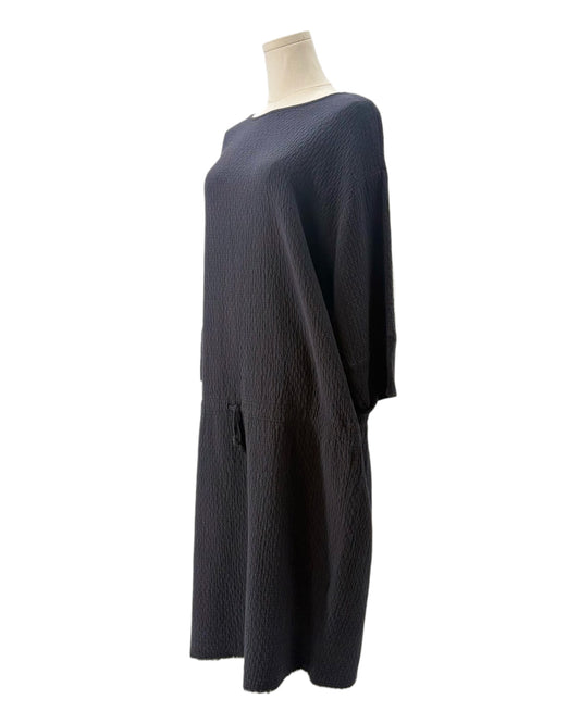 Black dress on a mannequin against a white background