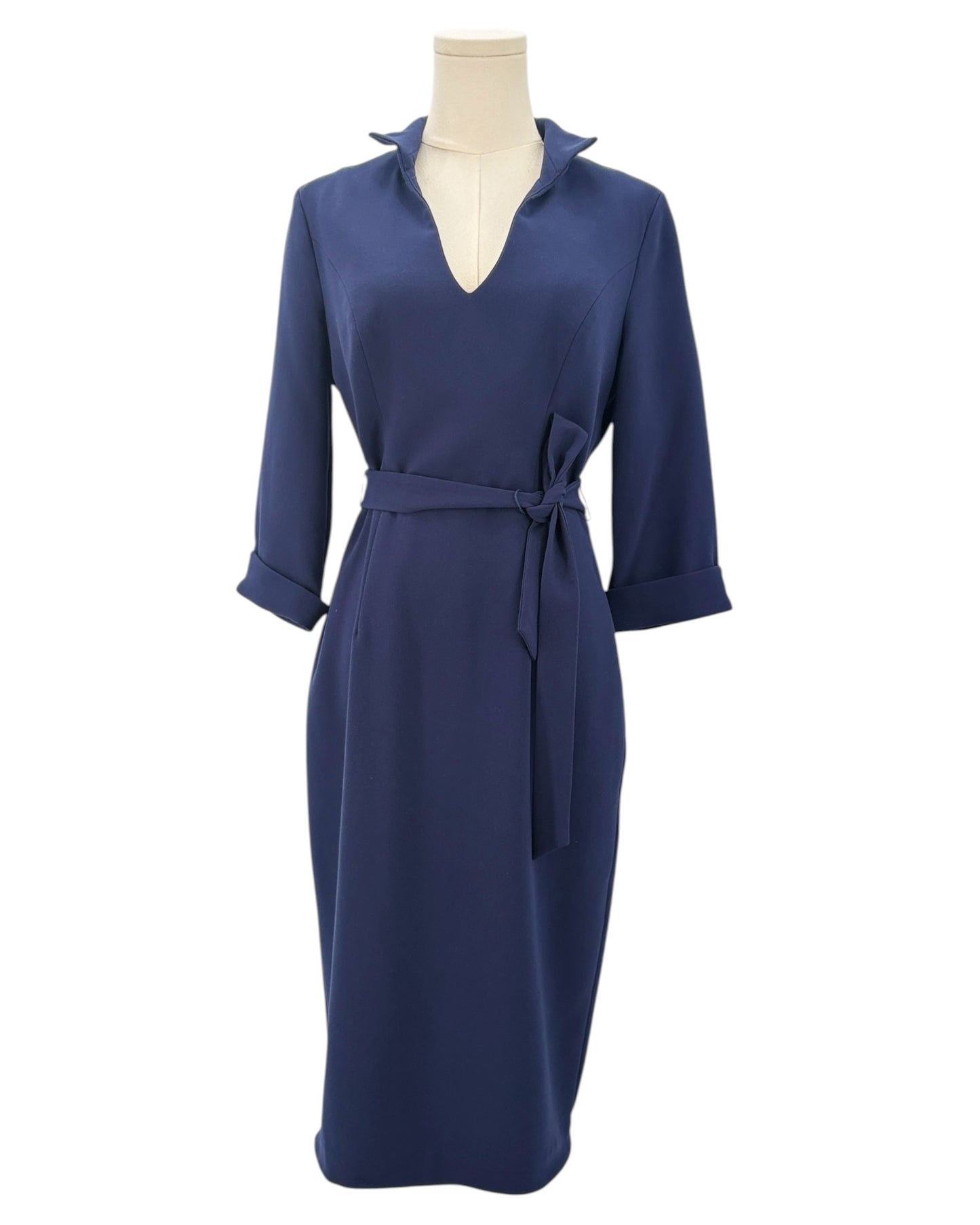 Navy blue dress on a mannequin against a white background