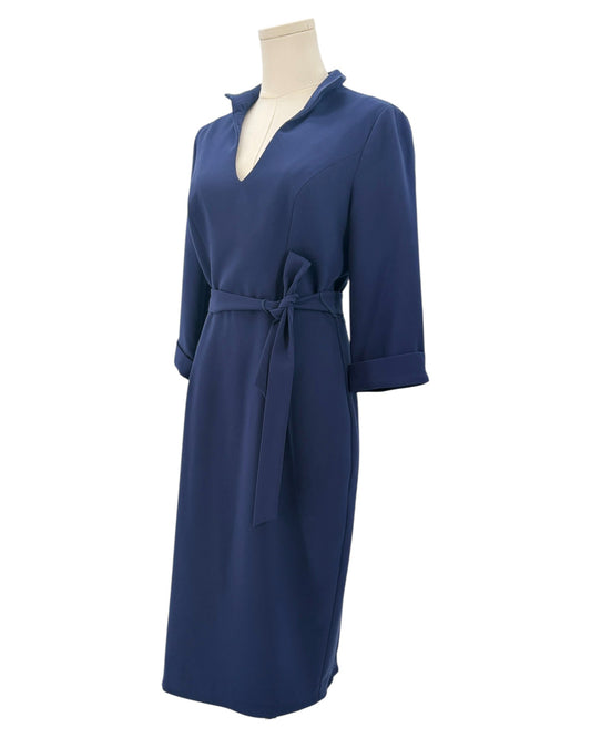 Navy blue dress on a mannequin against a white background