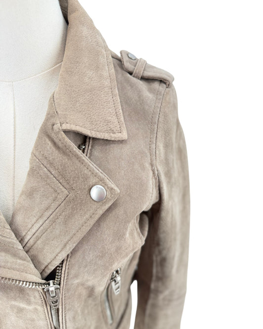 Close-up of a taupe suede motorcycle jacket displayed on a cream mannequin torso against a white background.