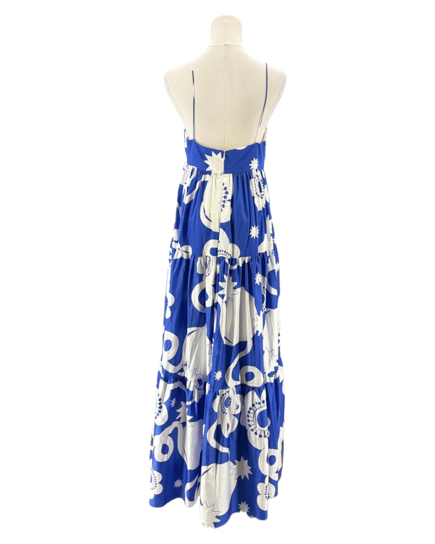 Blue dress with white patterns on a mannequin against a white background