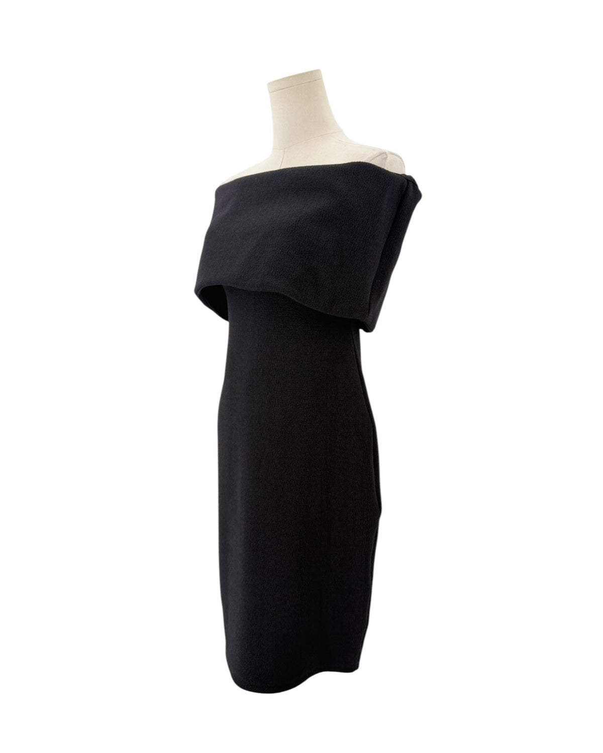 Black off-the-shoulder neckline, crinkled jersey fabric, midi length dress on a mannequin on a white background