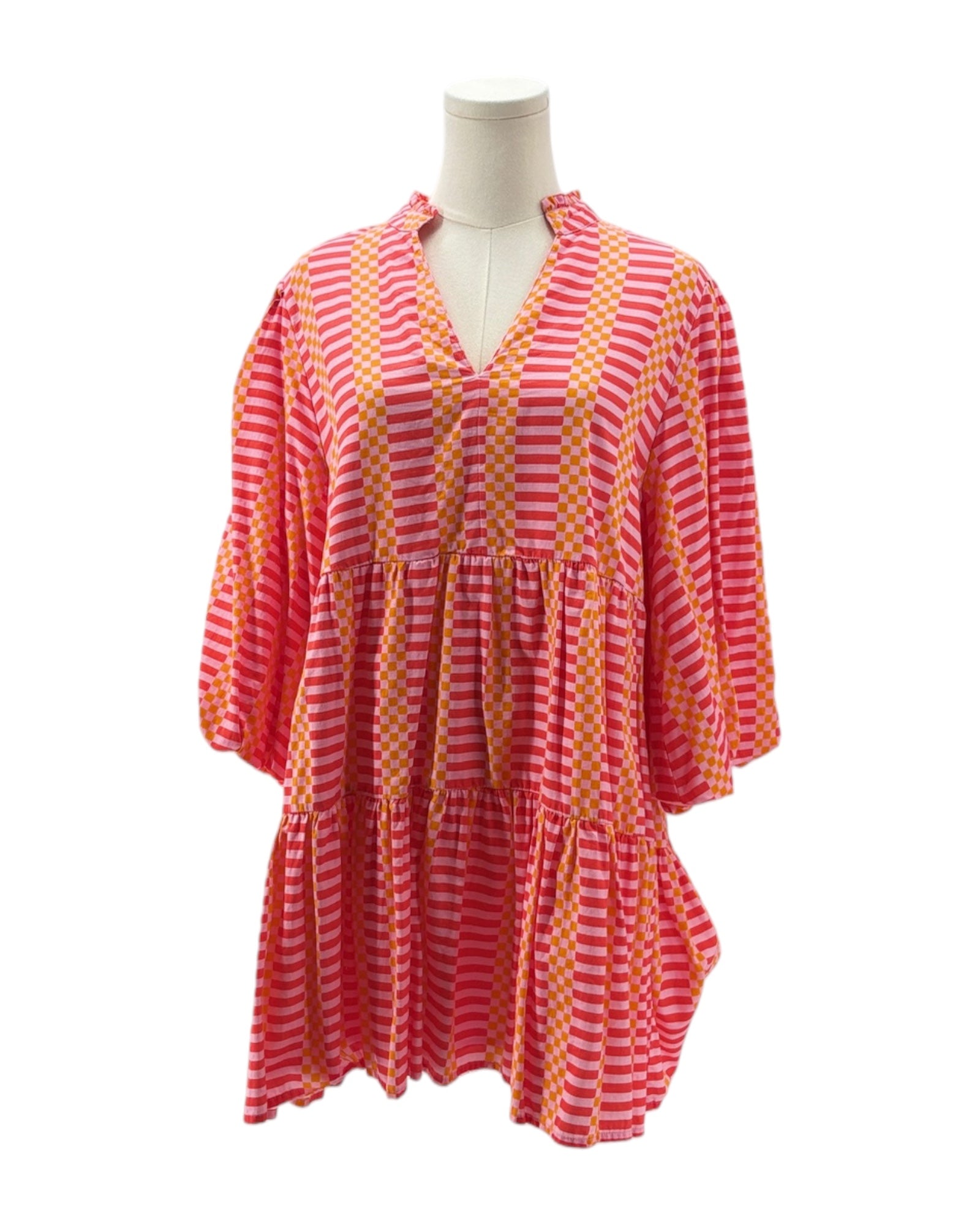 Pink and orange striped dress on a mannequin against a white background
